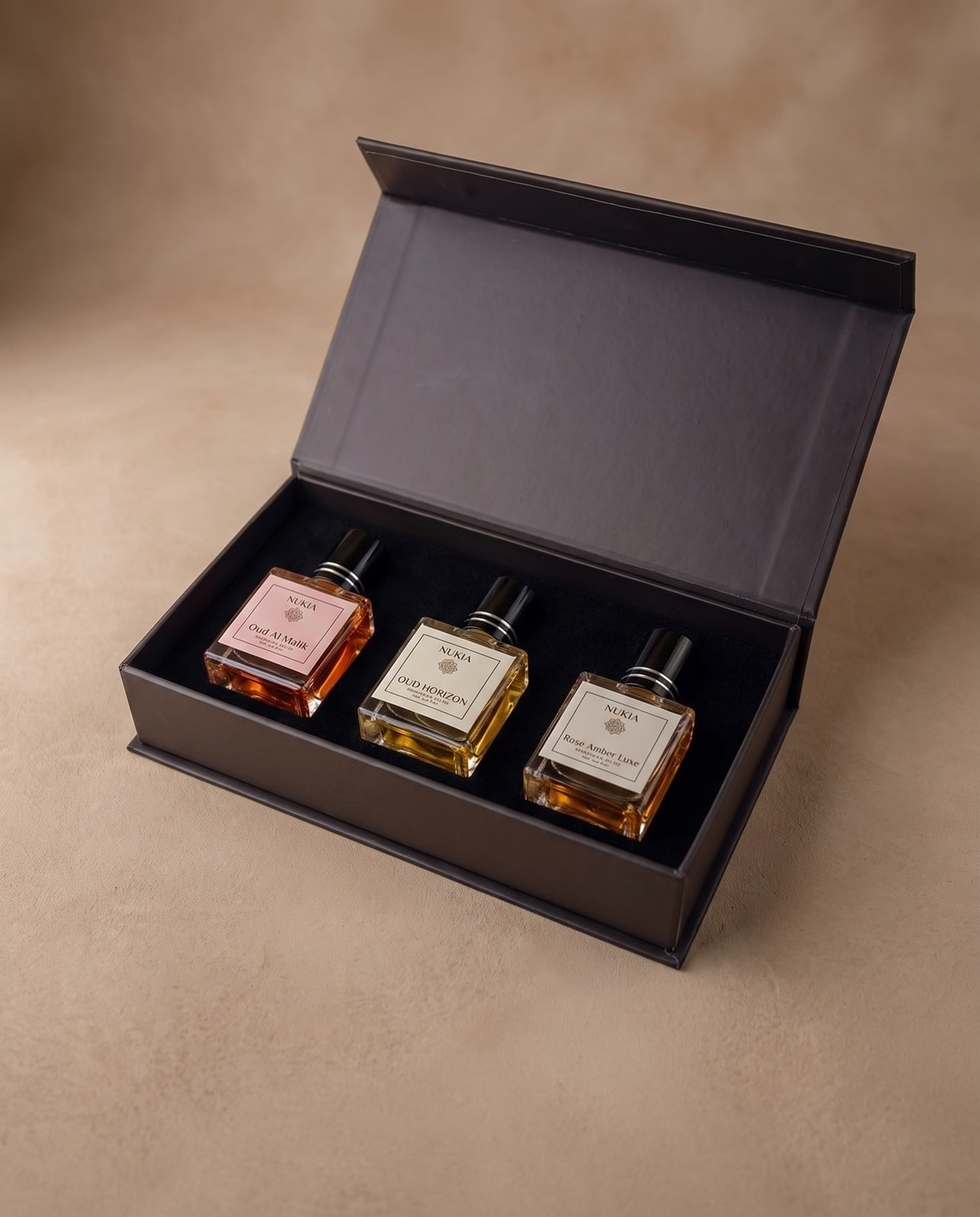 Nukia Signature Trio open gift box with three full-size perfume oils inside - Oud Al Malik, Oud Horizon, Rose Amber Luxe