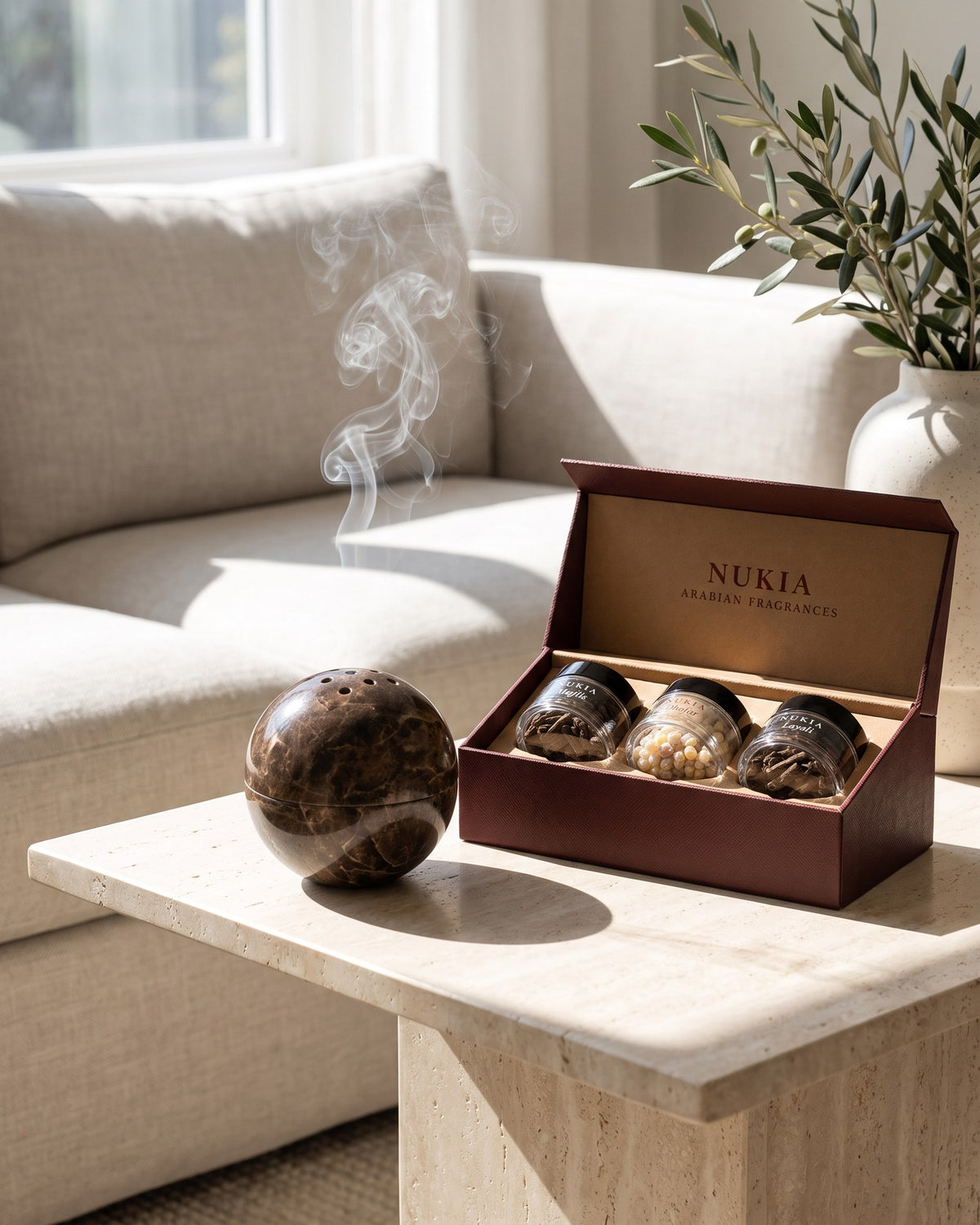 The globe on a side table next to the Bakhoor & Frankincense Trio
