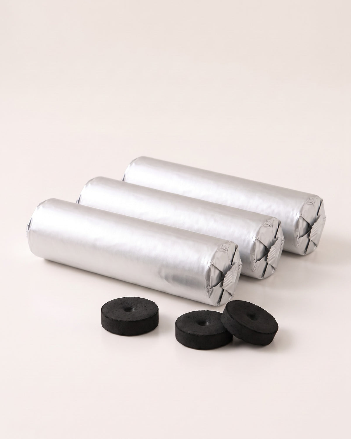 Three sealed foil rolls of quick-light charcoal discs