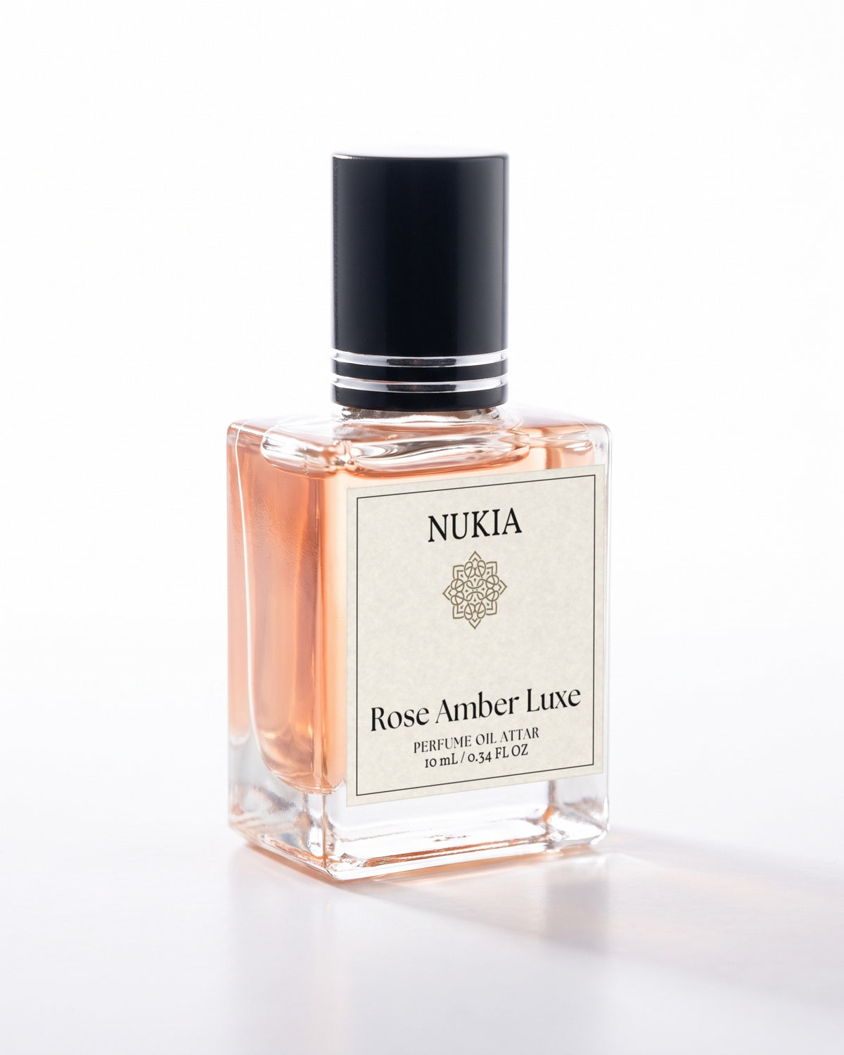 Rose Amber Luxe perfume oil, 10 mL bottle on white